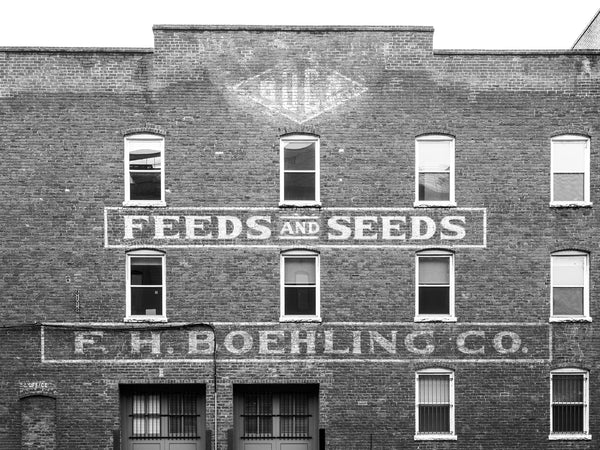Black and white photograph of the historic painted signs on the red brick front of the old F.H. Boehling Feed and Seed store in Richmond Virginia.