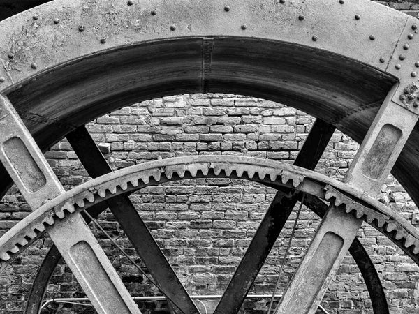 Black and white photograph of a geared mill wheel at the ruins of the old Tredegar Iron Works in Richmond, Virginia.