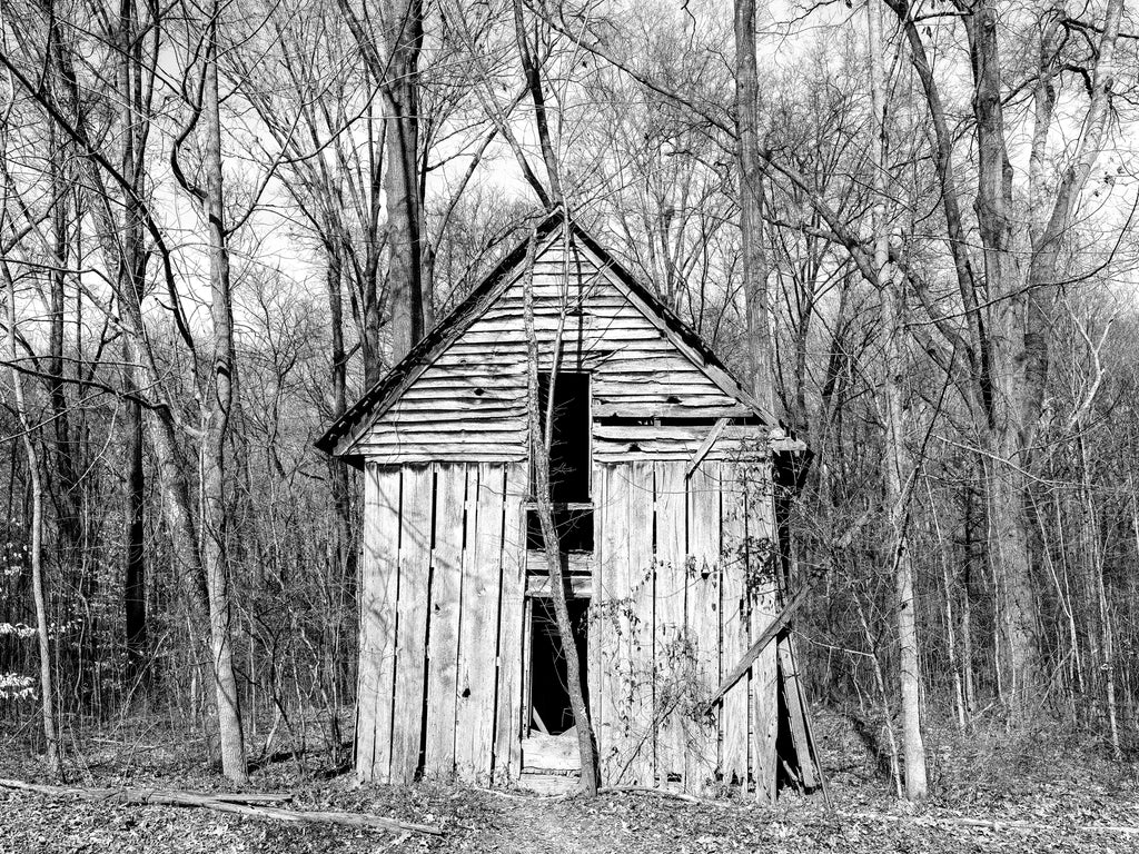 Black and white photograph of the abandoned 1920s farmhouse of farmer and sawmill operator William Eli Tillman (1894-1970) and his wife Mary Lessie Tillman, who raised four daughters here the rural American South.