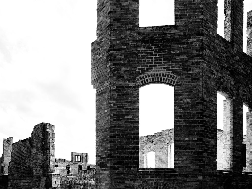 Black and white photograph of the ruins of the historic Hot Wells Hotel, built in the 1890s in San Antonio to serve as a luxury resort and hot springs bath for the rich and famous, including Teddy Roosevelt, actress Sarah Bernhardt, Cecil B. DeMille, Charlie Chaplin, Douglas Fairbanks, Sr., cowboy actor Tom Mix, Will Rogers, and Rudolph Valentino.
