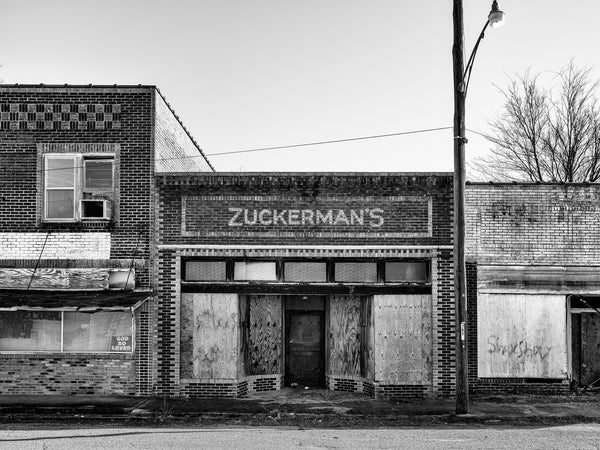 Black and white photograph of the front of the old Zuckerman's Store in the small Arkansas Delta town of Hughes.