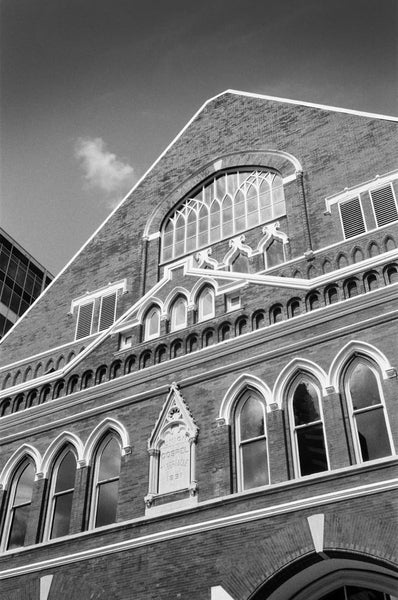 Black and white photograph of Nashville's famous Ryman Auditorium, the "mother church of country music," which begin as a tabernacle, and later served as home to the home of the Grand Ol' Opry. Today, it's one of the county's most venerated concert venues.