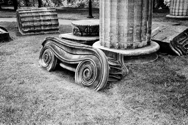 Black and white photograph of antique Greek Revival column fragments that can be found scattered around Nashville. These columns were originally part of the Tennessee Statehouse before a renovation. 