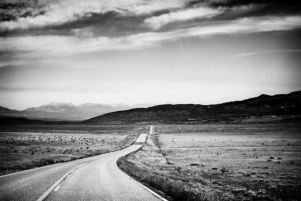 Black and white fine art landscape photograph of Colorado Highway 69 heading west toward the Rocky Mountains.