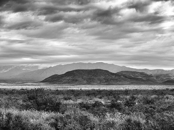 Black and white landscape photograph of the Sacramento Mountains on a stormy day in New Mexico.