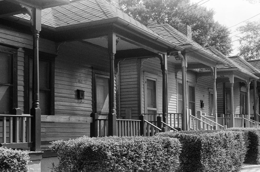 Black and white photograph of a row of shotgun houses across the street from Dr. Martin Luther King's birthplace in the Sweet Auburn neighborhood of Atlanta, Georgia.