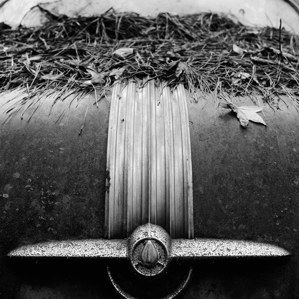 Ornament on Back of a Classic Car in a Junkyard - Black and White Photograph (Square Format) (555688_0005X)