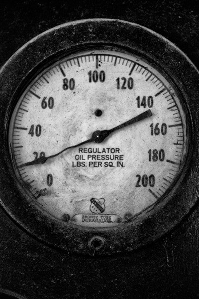 Black and white industrial photograph of an oil pressure gauge no longer in use at the old Sloss Furnaces in Birmingham, Alabama.