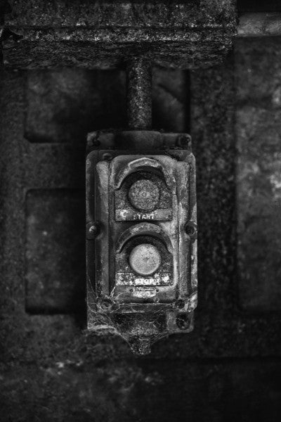 Black and white industrial photograph of a rusty and crusty start button at Sloss Furnaces in Birmingham, Alabama.