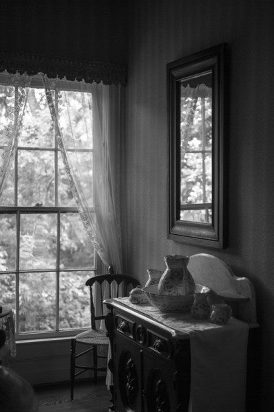 Black and white interior photograph of a bedroom inside Birmingham's historic Arlington House.