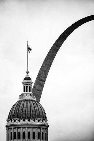 Black and white photograph of the famous Gateway Arch disappearing behind the dome of old St. Louis Courthouse, which was designed by William Singleton in 1839, and completed in stages between 1845 and 1862. 