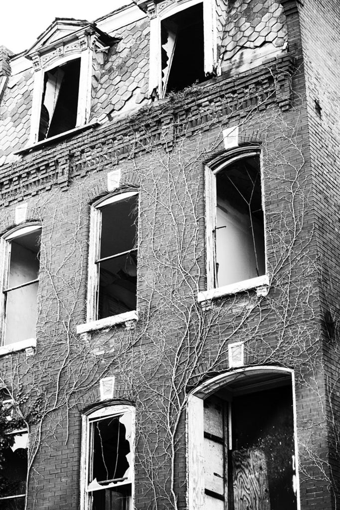 Black and white photograph of a beautiful old house in the College Hill neighborhood of St. Louis, now abandoned and in decline.