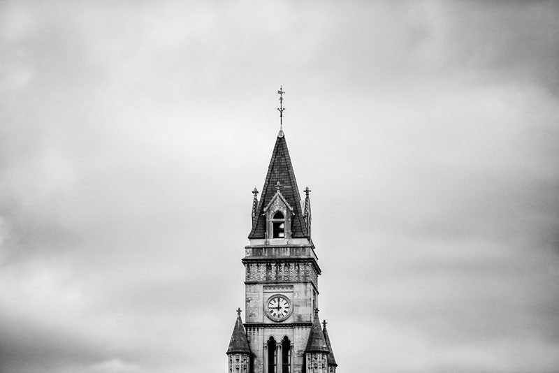 Black and white architectural photograph of the tower of the historic Customs House, framed alone against a dramatic sky, in downtown Nashville.