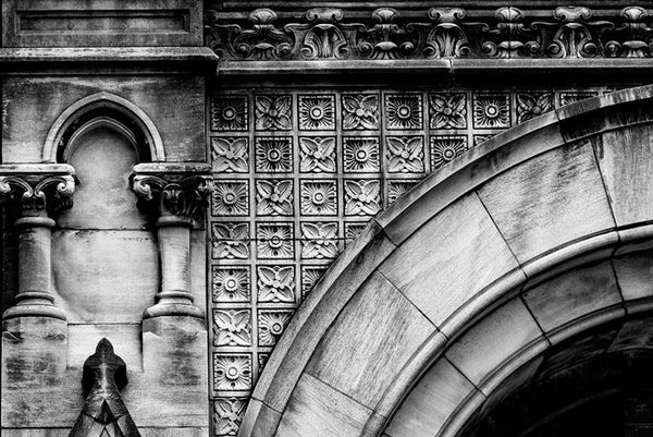 Black and white architectural detail photograph of an arch and ornate stonework on the front of the Customs House on Broadway in Nashville.