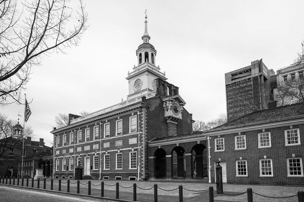Black and white photograph of the exterior of Independence Hall, one of the cradles of American Independence, photographed at street level on a late autumn day in Philadelphia.