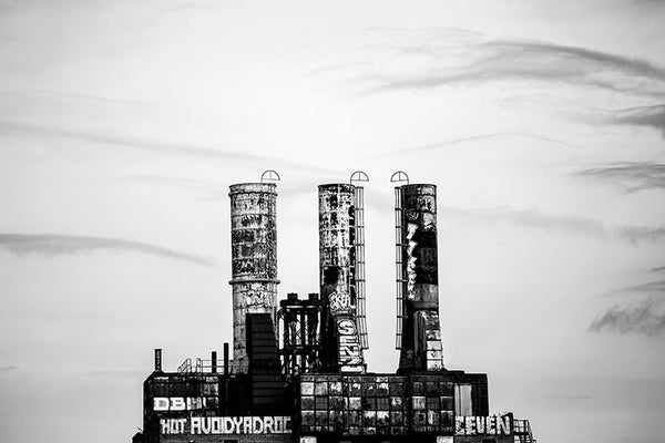 Black and white photograph of the three tall smoke stacks of the old Philadelphia Power Plant, seen from a distance.