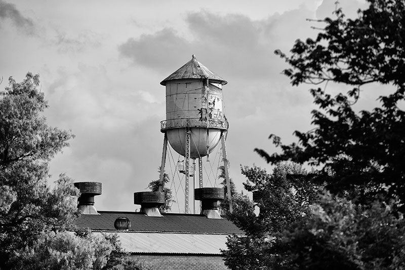 Black and white photograph of an old water tower in Lafayette, Louisiana. 