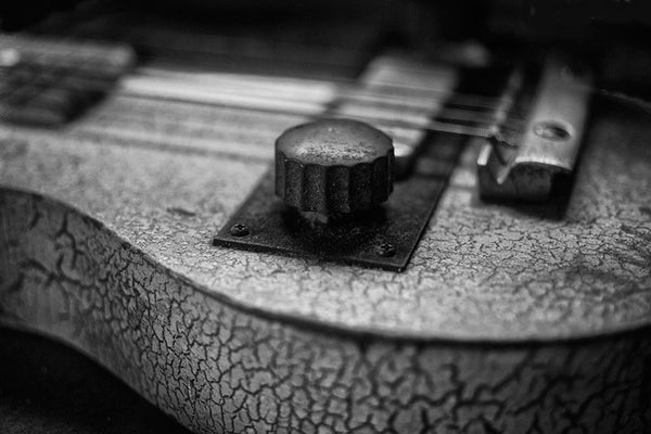 Black and white photograph of an old Cajun fiddle with cracked paint, found in the heart of Cajun country -- Lafayette, Louisiana.