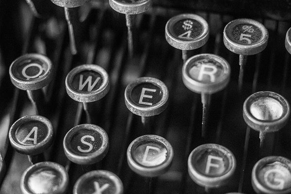Black and white photograph of the keys of an antique Underwood typewriter.
