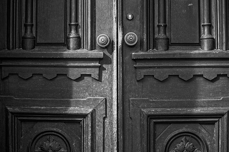 Black and white photograph of the historic wooden doors to Jubilee Hall, on the campus of Fisk University in Nashville, Tennessee.