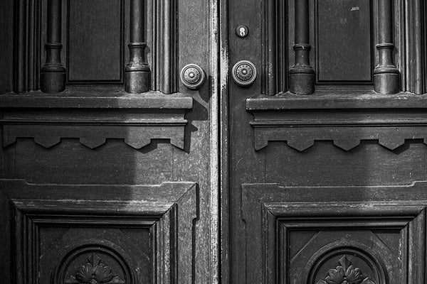 Black and white photograph of the historic wooden doors to Jubilee Hall, on the campus of Fisk University in Nashville, Tennessee.