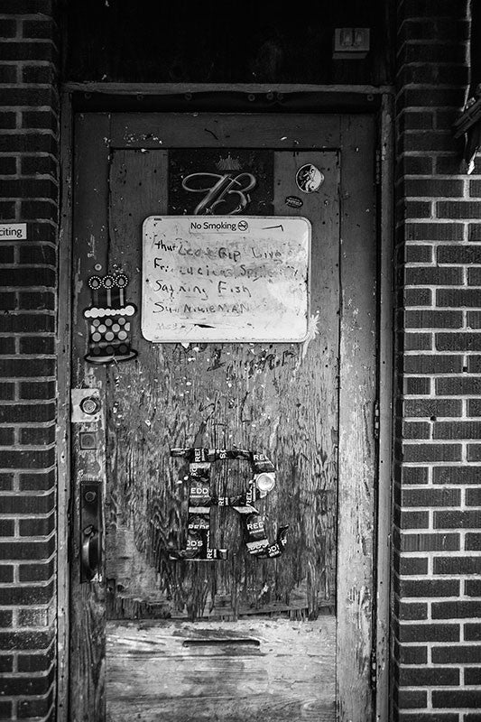 Black and white photograph of the door into Red's, a contemporary Delta blues juke joint in Clarksdale, Mississippi.