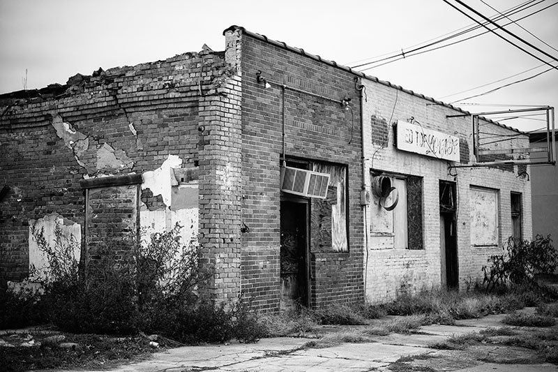 Black and white photograph of Smitty's Red Top Lounge, one of the great historic blues juke joints of the Mississippi Delta region, now abandoned and falling into ruin.