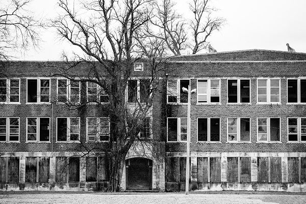 Black and white photograph of a huge, abandoned school building in Clarksdale, Mississippi.