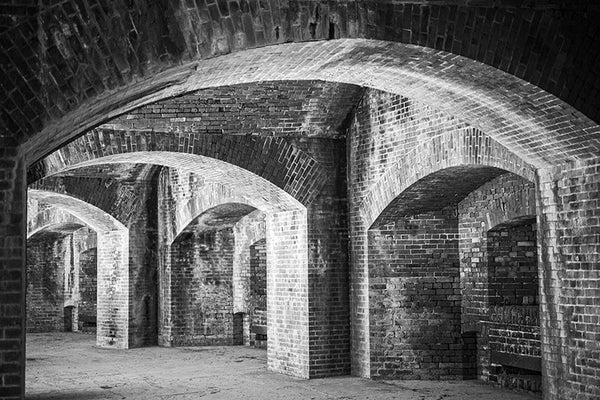 Black and white architectural photograph of the thick, brick arches and niches inside Fort Massachusetts, the Civil War-era fort perched atop the sandy sliver of Ship Island, 12 miles off the coast of Mississippi.