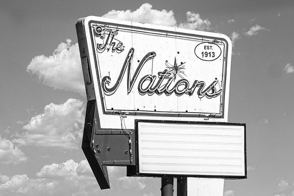 Black and white photograph of a vintage sign in The Nations, one of Nashville's oldest neighborhoods that's now up-and-coming in popularity.