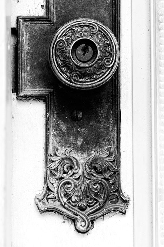 Black and white fine art photograph of a fancy door knob on a historic house in Houston, Texas.