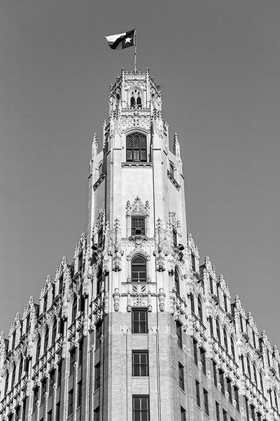 Black and white fine art architectural photograph of the Texas flag flying over The Emily Morgan Hotel in San Antonio, Texas. Built in 1924 to serve as a medical arts building, the iconic Gothic Revival building is now a hotel named after a heroine of Texas history, Emily Morgan (also known as Emily D. West), who was also the inspiration for the song "The Yellow Rose of Texas."