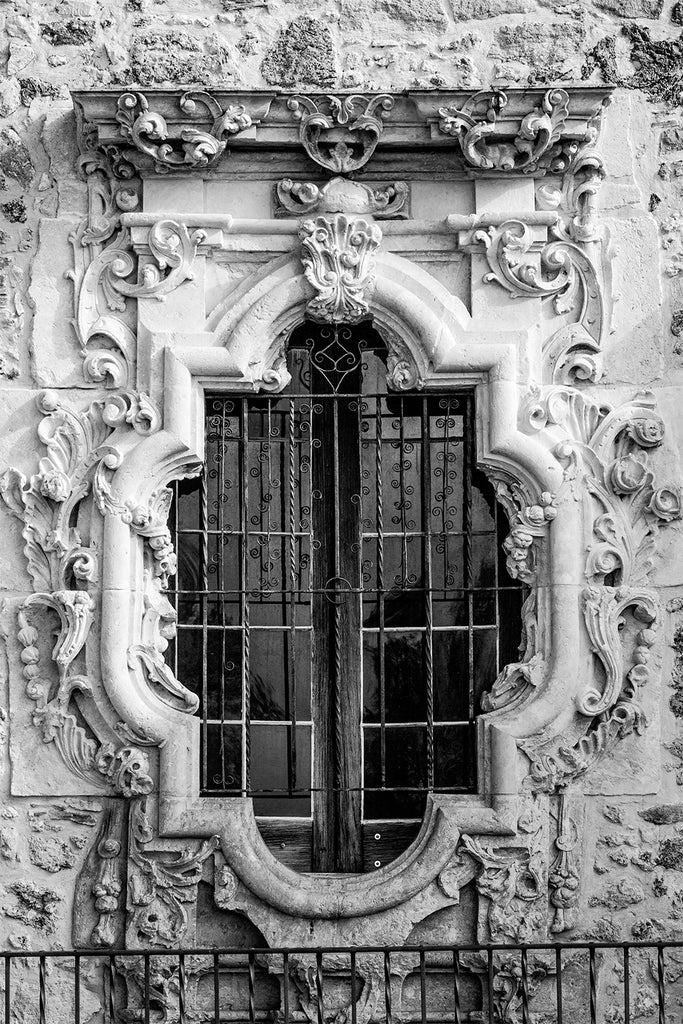 Detailed black and white fine art photograph of the famous Rose Window outside the church sacristy of Mission San Jose in San Antonio.