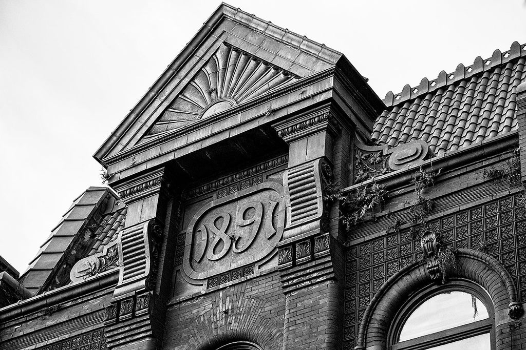 Black and white photograph of an ornate building with a stylized date that says "1891," located on King Street in Charleston, South Carolina.