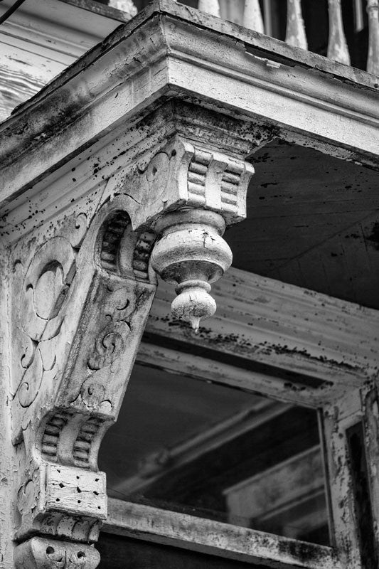 Black and white photograph of an architectural detail on a neglected but beautiful Victorian house in Charleston, South Carolina.