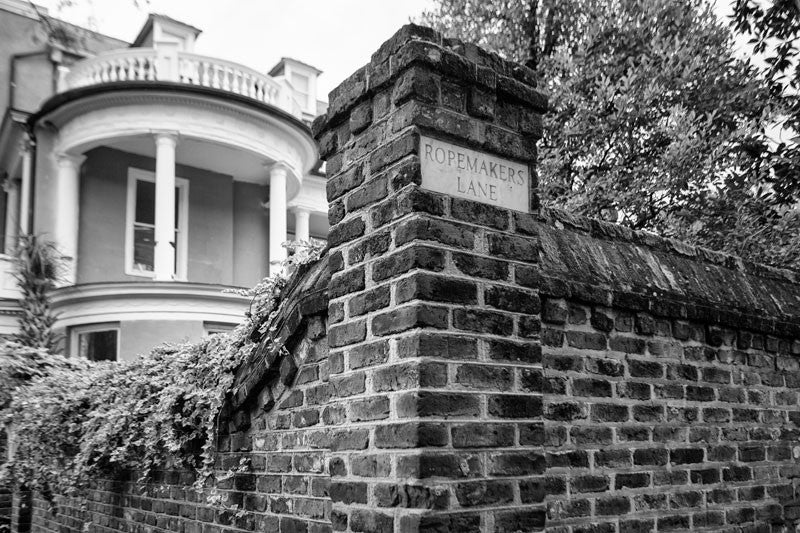 Black and white photograph of an ivy-covered wall on the corner of Meeting Street and Ropemaker's Lane in Charleston, South Carolina.