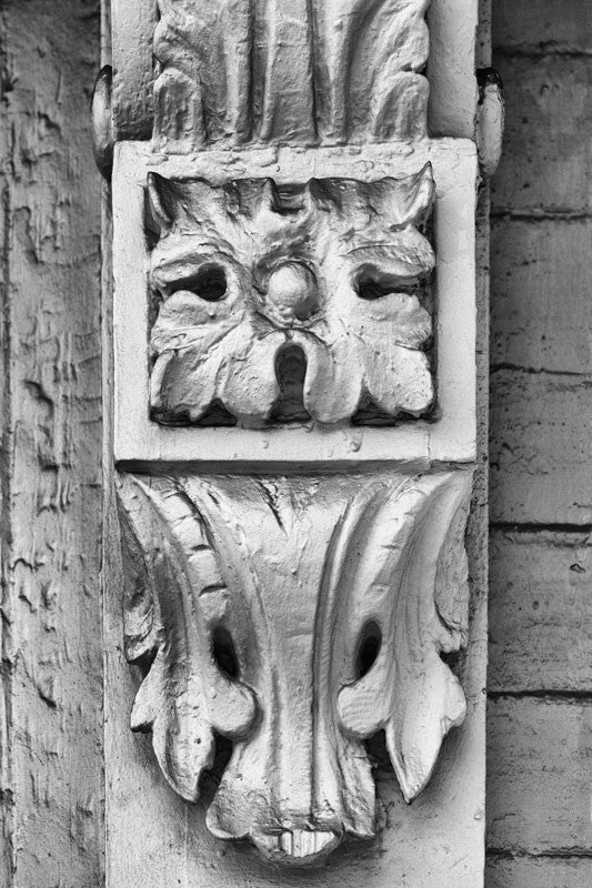 Black and white close-up detail photograph of antique woodwork on an old house in Charleston, South Carolina.