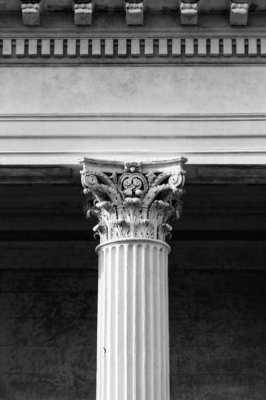 Black and white photograph of a classic Corinthian column on a historic building in Charleston, South Carolina.