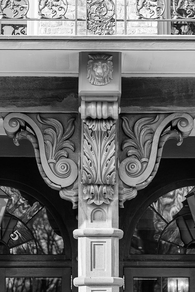 Black and white architectural detail photograph of beautiful, ornate wooden corbels on a historic building in Charleston. 