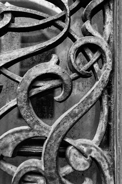Black and white detail photograph of the ornate antique iron work on the exterior doors and windows of the old Farmers and Exchange Bank, built circa 1853.