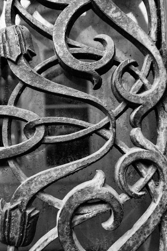 Black and white photograph of the iron work over the exterior door and window glass at the old Farmers and Exchange Bank, built in 1853.