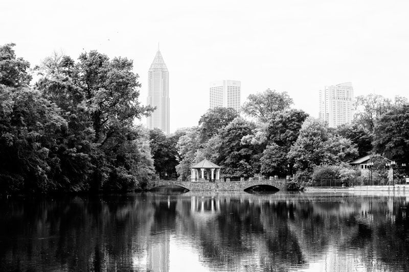 Black and white photograph of the Midtown Atlanta skyline, and the Piedmont Park gazebo reflecting into Lake Clara Meer in early morning light.
