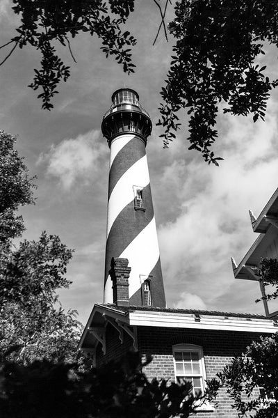 Black and white photograph of the St. Augustine lighthouse and the residence of the lighthouse keeper in St. Augustine, Florida. The current lighthouse stands at the north end of Anastasia Island and was built in 1874.