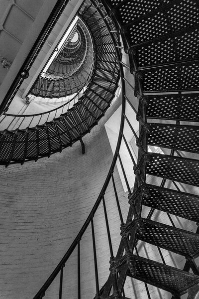 Black and white architectural photograph of the metal stairs spiraling upwards toward the top of the St. Augustine Lighthouse in St. Augustine, Florida.