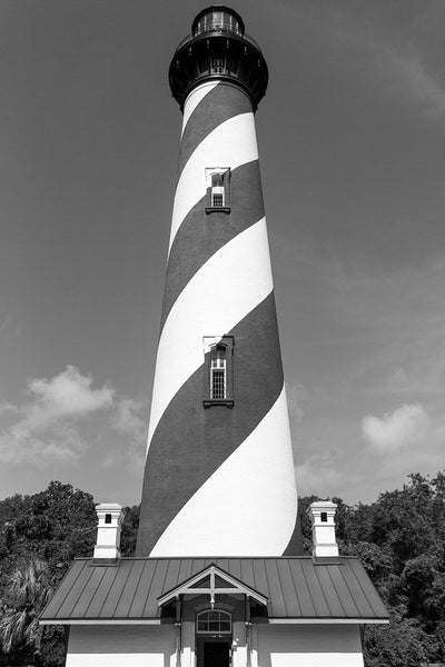 Black and white photograph of the St. Augustine Lighthouse against the clear, blue sky in St. Augustine, Florida. The current lighthouse stands at the north end of Anastasia Island and was built in 1874.