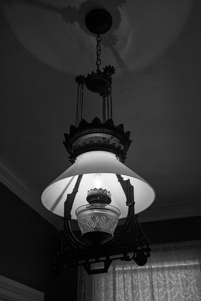 Black and white photograph of an antique lamp in the old lighthouse keeper's residence at the St. Augustine Lighthouse in Florida.
