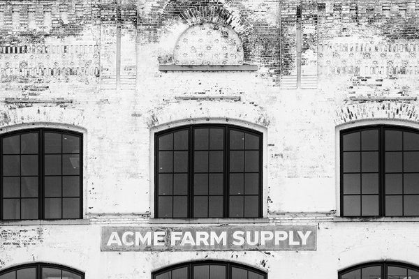 Black and white photograph of  the old Acme Farm Supply building on lower Broadway in downtown Nashville, Tennessee.