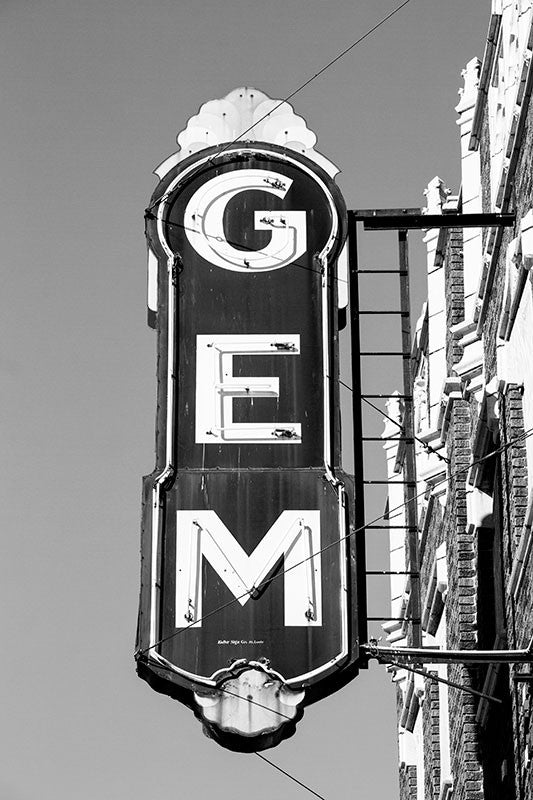 Black and white photograph of the vintage sign outside the abandoned Gem Theatre in Cairo, Illinois. A movie theatre has existed on the location since 1910, with a reconstruction in the 1930s after a fire gutted the building. The theatre closed forever in 1978.