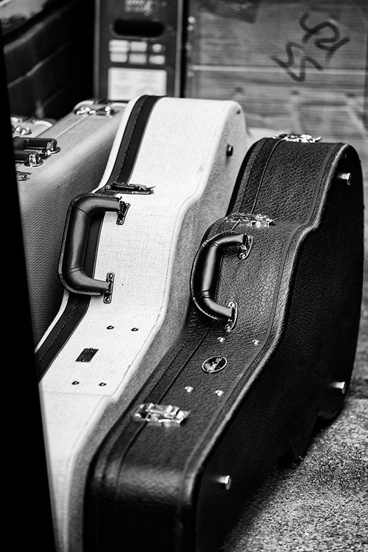 Black and white photograph of guitar cases and other gear waiting off stage at a gig in Nashville, Tennessee.