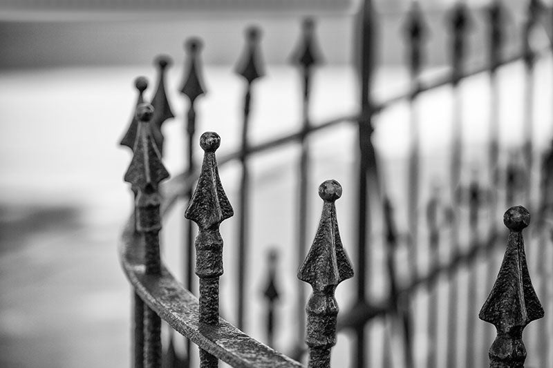 Black and white photograph of a beautiful curved iron work fence around a circa 1852 building near downtown Nashville, Tennessee.